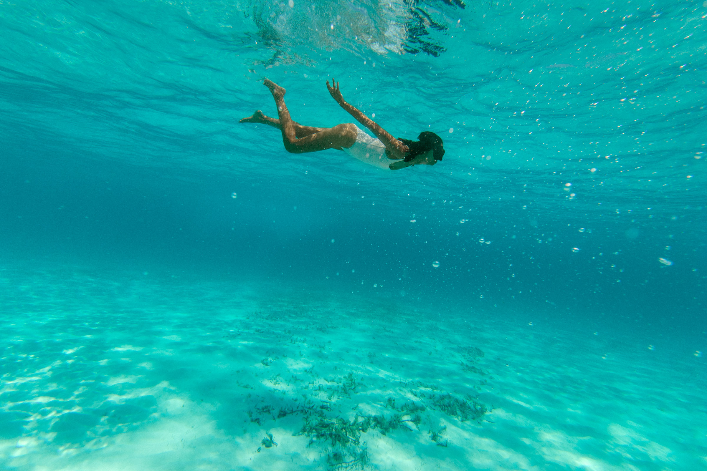 Female solo traveler swimming in the ocean alone Female solo traveler swimming in the ocean alone