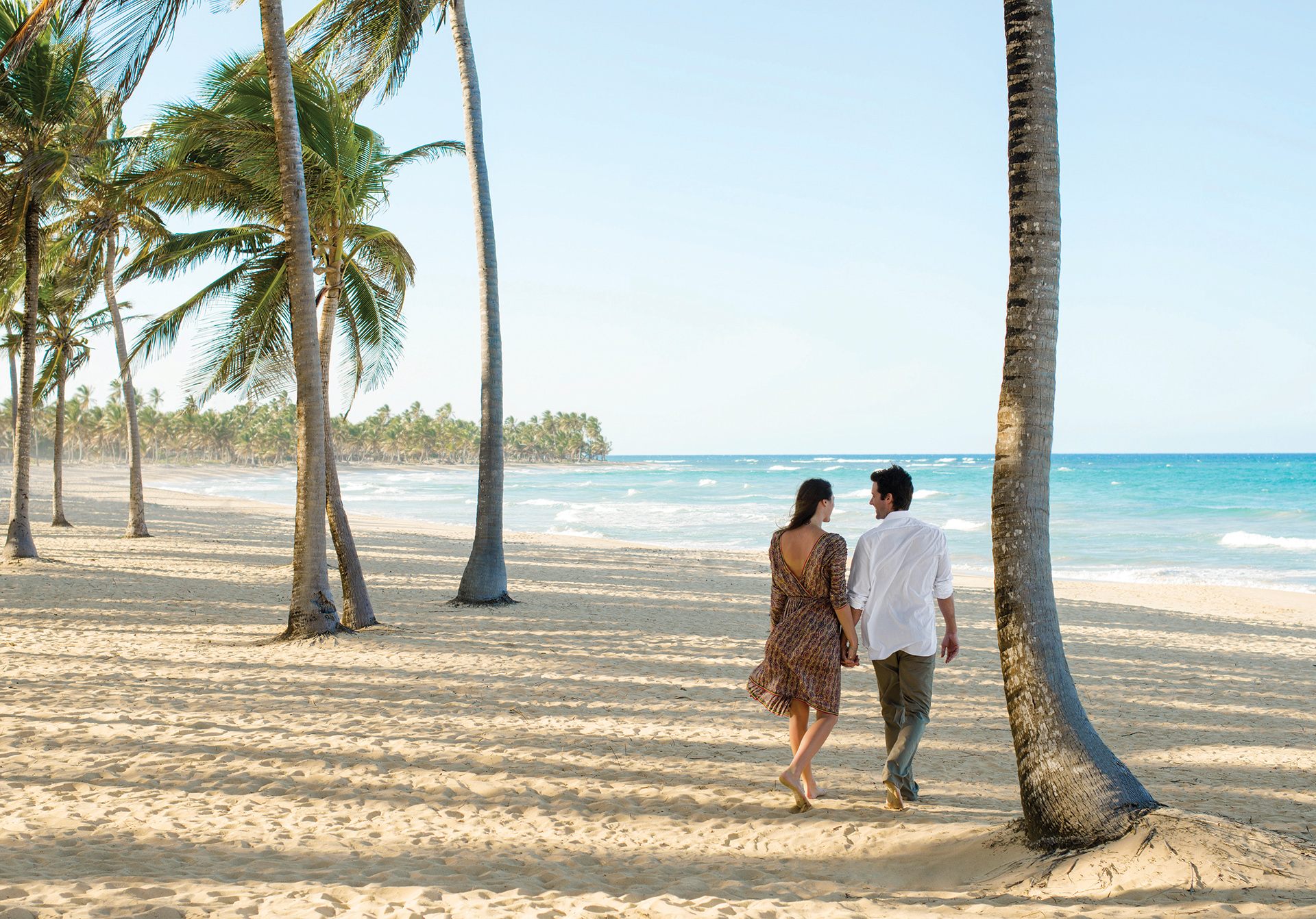 Couple walking along the beach in Excellence Punta Cana Couple walking along the beach in Excellence Punta Cana