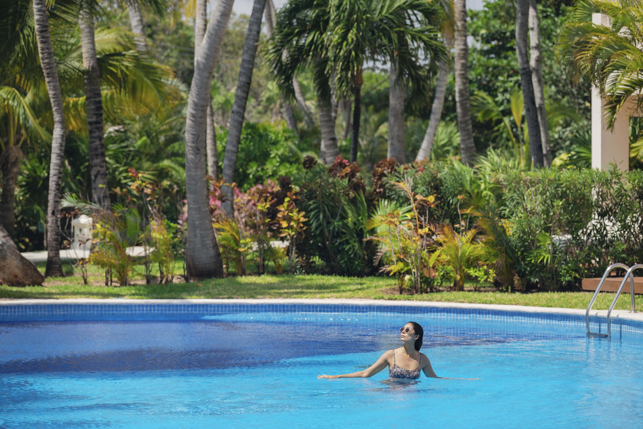 Happy female traveller alone in a Cancun resort Happy female traveller alone in a Cancun resort