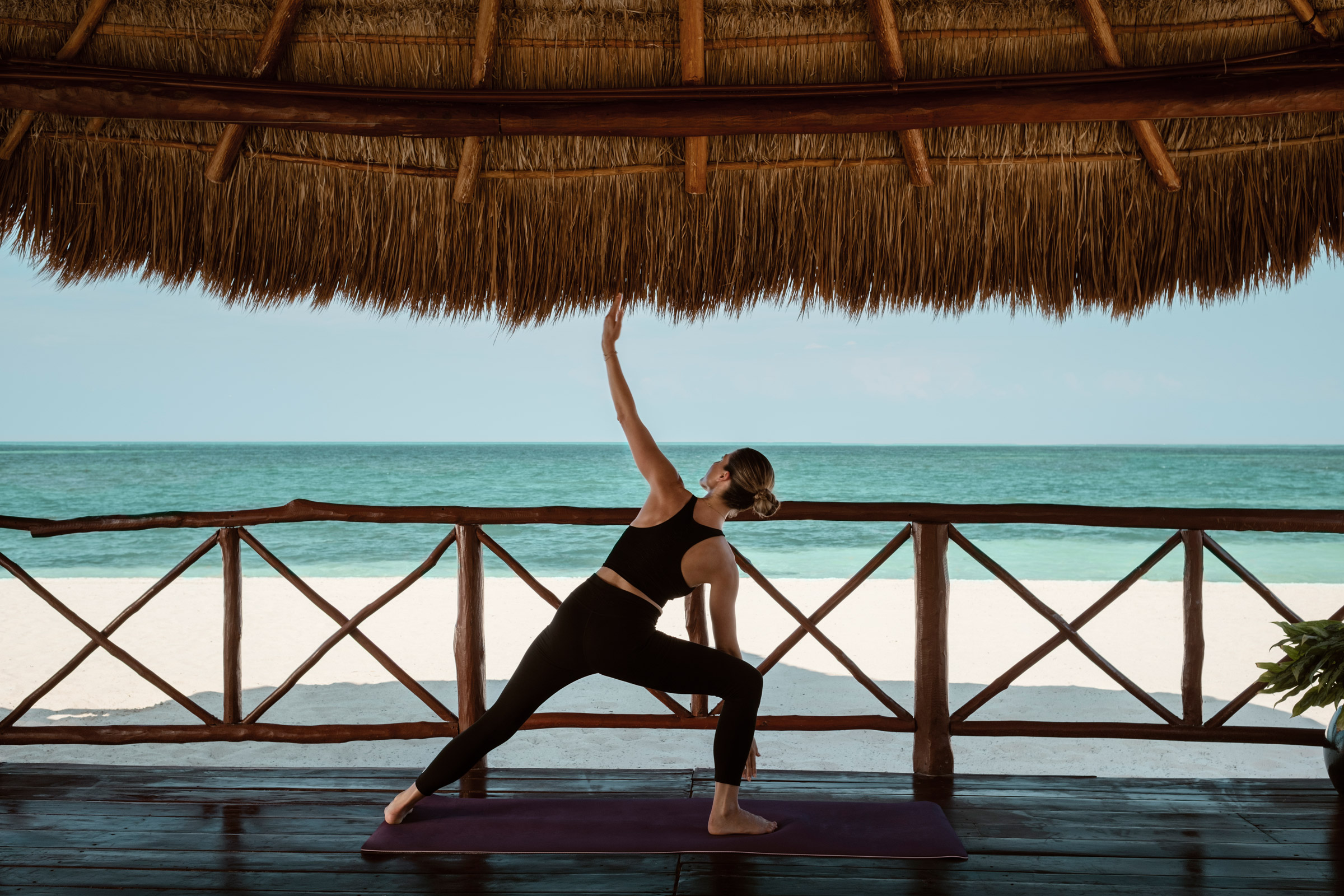 Woman joining a Yoga class in her resort in Cancun Woman joining a Yoga class in her resort in Cancun