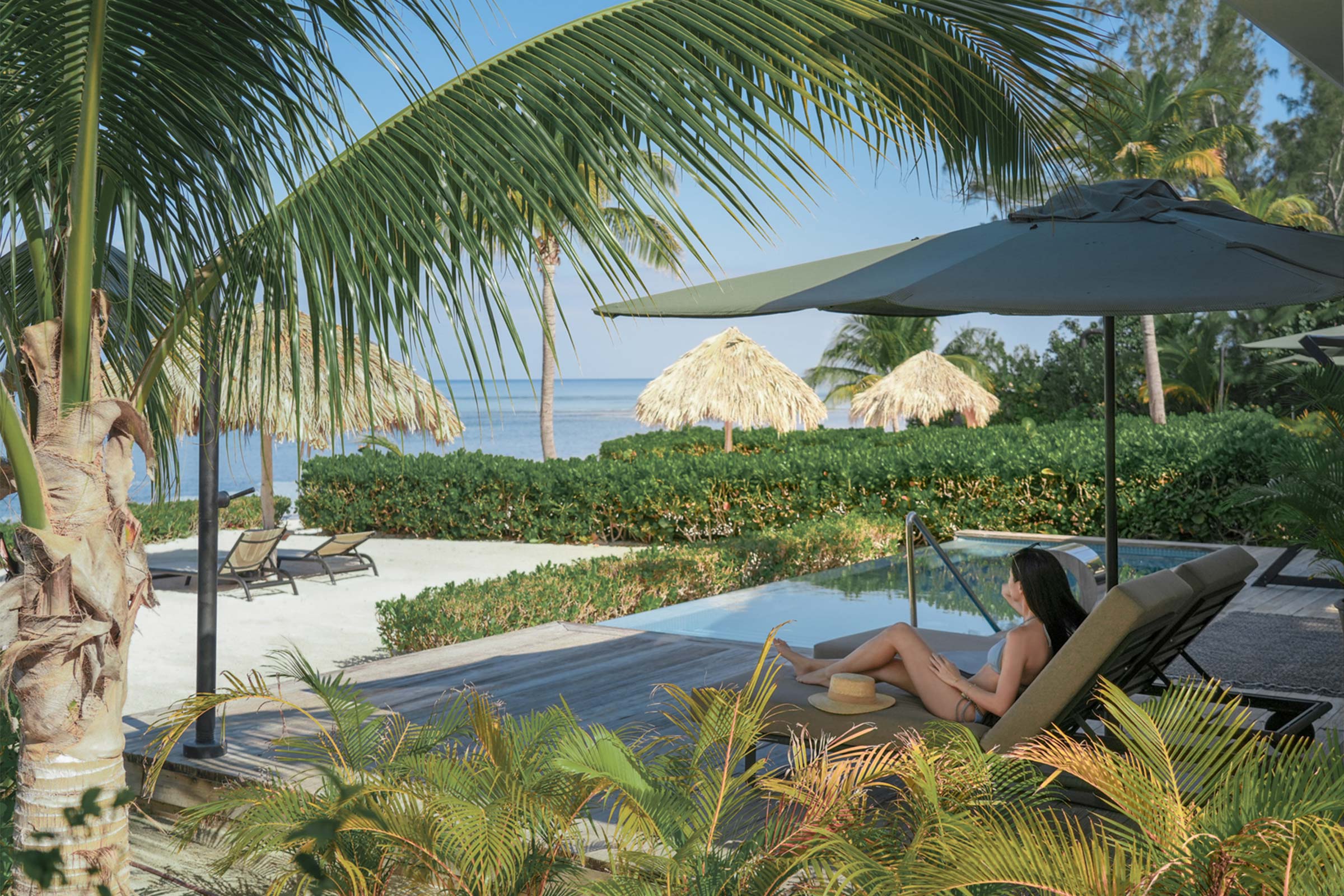 Woman enjoying the safety of her Jamaican resort as she rests in the shade Woman enjoying the safety of her Jamaican resort as she rests in the shade