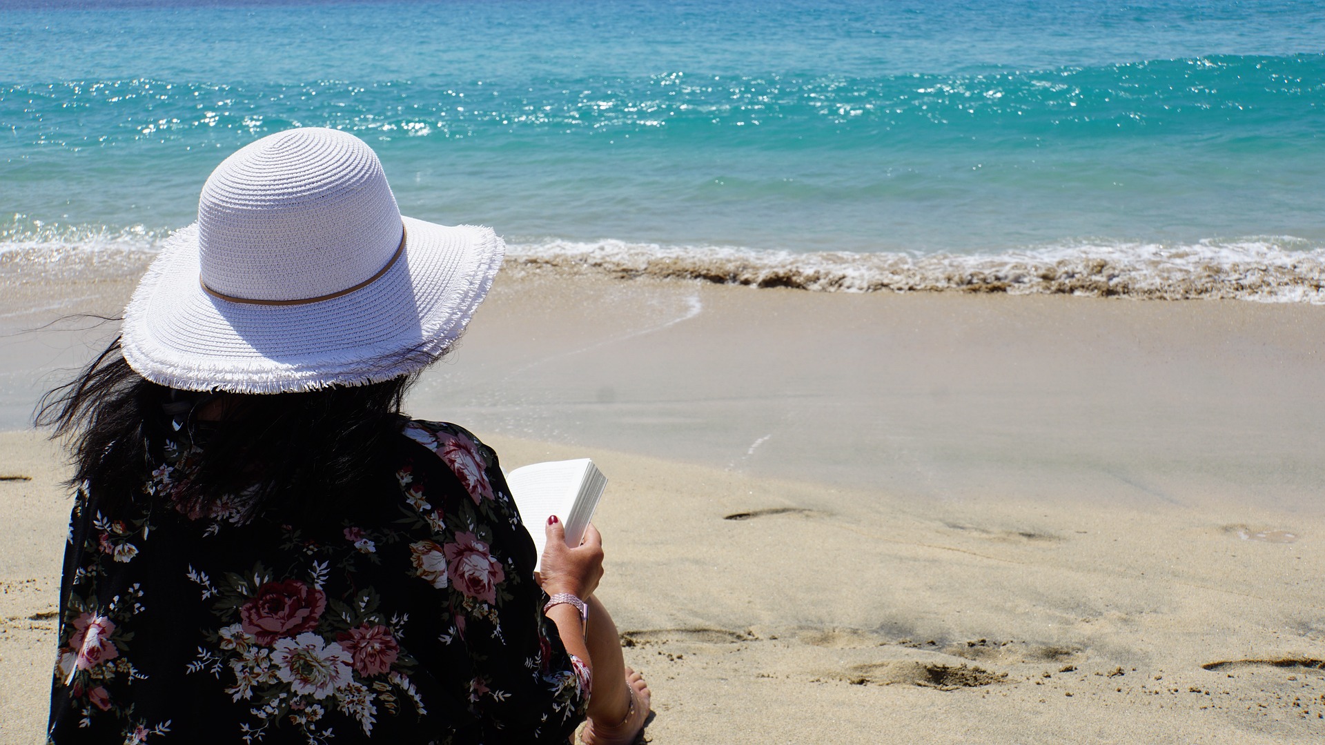Lady reading a book on the beach in the Caribbean Lady reading a book on the beach in the Caribbean